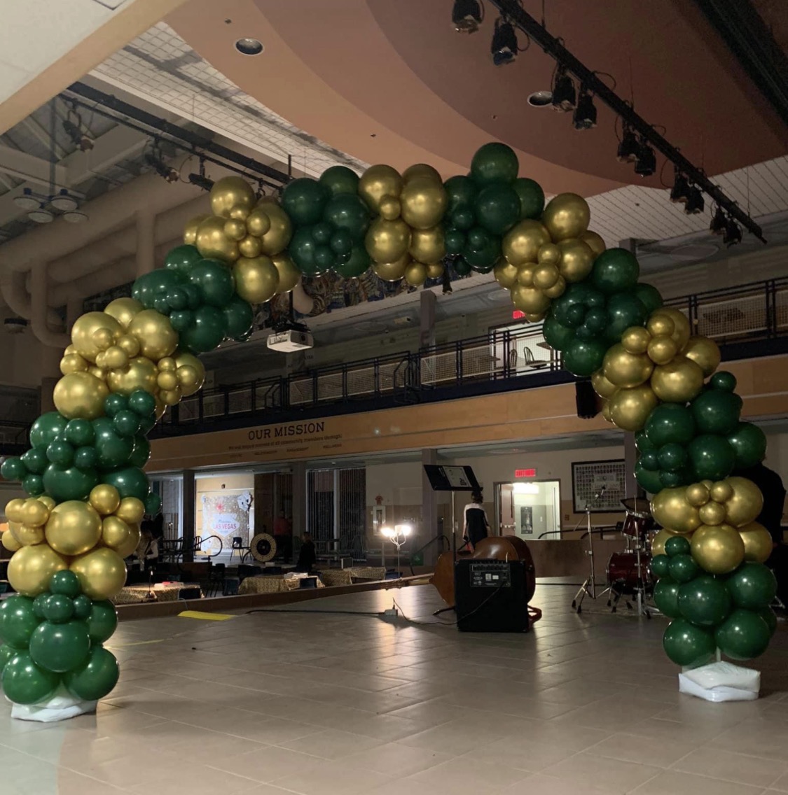 Green and gold balloon arch